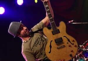 GuitarPlayerHoldingUpGuitar